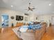 Cozy living room featuring wood floors, a ceiling fan, and comfortable seating at 4292 Tahiti Dr, Hernando Beach, FL 34607