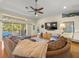 Bright living room with wood floors, fan, large windows, and access to the outdoor deck at 4292 Tahiti Dr, Hernando Beach, FL 34607