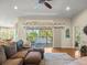 Inviting living room featuring hardwood floors, sliding glass doors to the lanai, and a comfortable sectional sofa at 4292 Tahiti Dr, Hernando Beach, FL 34607