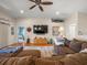 Comfortable living room featuring a ceiling fan, large television, and access to other rooms at 4292 Tahiti Dr, Hernando Beach, FL 34607