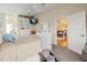 Comfortable main bedroom with soft decor, ceiling fan, and doorway to the living room at 4292 Tahiti Dr, Hernando Beach, FL 34607