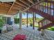 Covered patio overlooking waterfront with stairs to upper deck and hammock at 4292 Tahiti Dr, Hernando Beach, FL 34607