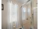 Modern shower with glass enclosure, a tiled floor, and a round window at 4292 Tahiti Dr, Hernando Beach, FL 34607