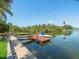 Waterfront view with boat dock, canal, and lush greenery at 4292 Tahiti Dr, Hernando Beach, FL 34607