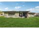 Backyard with lush lawn and the home's exterior at 4424 Whitetail Ln, New Port Richey, FL 34653