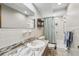 Bathroom featuring a shower, vanity, decorative shelf, and a large mirror at 4424 Whitetail Ln, New Port Richey, FL 34653