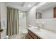 Clean bathroom with white tile, a vanity, a toilet, and a shower with a curtain at 4424 Whitetail Ln, New Port Richey, FL 34653