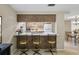 Kitchen bar with stools that opens to the kitchen, with appliances and seating at 4424 Whitetail Ln, New Port Richey, FL 34653