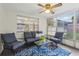 Relaxing sunroom with comfortable seating and a ceiling fan at 4424 Whitetail Ln, New Port Richey, FL 34653