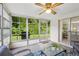 Bright sunroom with screened windows and sliding door to backyard at 4424 Whitetail Ln, New Port Richey, FL 34653