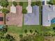 Aerial view of rooftops with lush green lawns, mature trees, and well-maintained landscaping in a neighborhood at 4485 Gevalia Dr, Brooksville, FL 34604