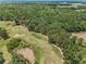 Scenic aerial view overlooking the golf course with mature trees at 4485 Gevalia Dr, Brooksville, FL 34604