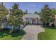 Stunning aerial view of the home showcasing its elegant architecture, lush landscaping, and a spacious driveway at 4485 Gevalia Dr, Brooksville, FL 34604