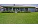Expansive backyard featuring a lush green lawn and well-maintained shrubbery at 4485 Gevalia Dr, Brooksville, FL 34604