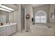 Bright bathroom featuring a soaking tub, walk-in shower, and vanity with ample counter space at 4485 Gevalia Dr, Brooksville, FL 34604
