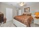 Cozy bedroom with plush carpeting, ceiling fan, and comfortable bed with decorative pillows at 4485 Gevalia Dr, Brooksville, FL 34604