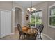 Charming dining area with a round table, wood chairs, and a view of the outdoors at 4485 Gevalia Dr, Brooksville, FL 34604