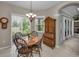 Cozy dining area featuring a round table, wood chairs, and natural light from the window at 4485 Gevalia Dr, Brooksville, FL 34604