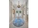 Inviting foyer with a decorative rug, chandelier, and arched doorways, creating a grand entrance at 4485 Gevalia Dr, Brooksville, FL 34604