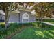 Beautiful landscaping featuring mature trees and vibrant green ground cover around the home at 4485 Gevalia Dr, Brooksville, FL 34604