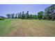 The expansive golf course is lush and green with mature trees in the background at 4485 Gevalia Dr, Brooksville, FL 34604