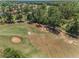 Aerial of golf course featuring lush greenery, trees and sand traps at 4485 Gevalia Dr, Brooksville, FL 34604