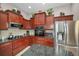 The kitchen features modern stainless steel appliances, dark wood cabinets, and granite countertops at 4485 Gevalia Dr, Brooksville, FL 34604