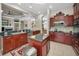 Spacious kitchen with a center island, granite countertops, and dark wood cabinetry at 4485 Gevalia Dr, Brooksville, FL 34604