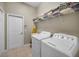 Functional laundry room featuring washer, dryer, shelving, and a utility sink at 4485 Gevalia Dr, Brooksville, FL 34604