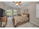 Comfortable main bedroom with a ceiling fan, soft carpet, and a sliding glass door to the outside at 4485 Gevalia Dr, Brooksville, FL 34604