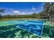 Bright blue and green pickleball courts with white lines and netting surrounded by a fence in a lovely community at 4485 Gevalia Dr, Brooksville, FL 34604