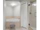 Bright bathroom featuring a soaking tub, a glass enclosed shower, and neutral tile at 4516 Seagull Dr # 512, New Port Richey, FL 34652