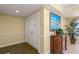 Well-lit hallway featuring a decorative console table with a picture and plants at 4516 Seagull Dr # 512, New Port Richey, FL 34652