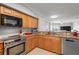 Open-concept kitchen featuring stainless steel appliances and granite countertops, seamlessly flowing into the living area at 4516 Seagull Dr # 512, New Port Richey, FL 34652