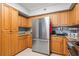 Modern kitchen featuring stainless steel refrigerator, granite countertops, and ample storage space at 4516 Seagull Dr # 512, New Port Richey, FL 34652