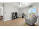 Comfortable living room featuring wood-look floors, ceiling fan, balcony with lovely water views and comfortable seating at 4516 Seagull Dr # 512, New Port Richey, FL 34652