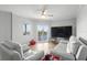 Bright living room featuring wood-look floors, ceiling fan, balcony with lovely water views and comfortable seating at 4516 Seagull Dr # 512, New Port Richey, FL 34652