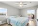 Bright primary bedroom with wood-look floors, stylish decor, and a balcony with water views at 4516 Seagull Dr # 512, New Port Richey, FL 34652