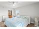 Bright primary bedroom with wood-look floors, stylish decor, and an ensuite bathroom at 4516 Seagull Dr # 512, New Port Richey, FL 34652
