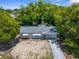 Aerial view of single-story home showcasing a long driveway and mature trees at 4520 Blanche St, New Port Richey, FL 34652