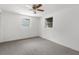 Bright bedroom featuring neutral walls, ceiling fan, carpet and two windows offering natural light at 4520 Blanche St, New Port Richey, FL 34652