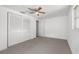 Spacious bedroom with carpet, ceiling fan, and dual closets offering ample storage space at 4520 Blanche St, New Port Richey, FL 34652
