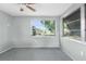 Bright bedroom featuring neutral walls, ceiling fan, carpet and two windows offering natural light at 4520 Blanche St, New Port Richey, FL 34652