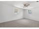Bedroom featuring neutral walls, ceiling fan, carpet and two windows offering natural light at 4520 Blanche St, New Port Richey, FL 34652