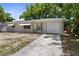 An updated single-story home with a light exterior, attached garage, and newly poured concrete driveway at 4520 Blanche St, New Port Richey, FL 34652