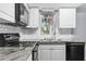 Kitchen shot featuring granite countertops, stainless appliances, white cabinets, and white subway tile backsplash at 4520 Blanche St, New Port Richey, FL 34652