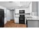 Tastefully designed kitchen showcasing sleek black appliances, crisp white cabinets, and durable granite countertops at 4520 Blanche St, New Port Richey, FL 34652
