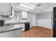 Bright kitchen featuring modern countertops, white cabinets, laminate flooring, and stainless steel appliances at 4520 Blanche St, New Port Richey, FL 34652