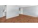 Living room featuring beautiful wood floors, neutral wall color, and easy access to the kitchen at 4520 Blanche St, New Port Richey, FL 34652