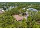 Aerial view of home surrounded by trees in a quiet neighborhood at 4960 Hidden Knob Trl, Spring Hill, FL 34609